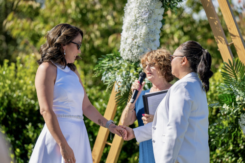 The bride and groom exchanging at an outside location.