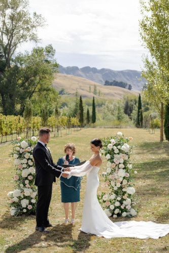 Bride and groom exchanging vows in beautiful country setting.