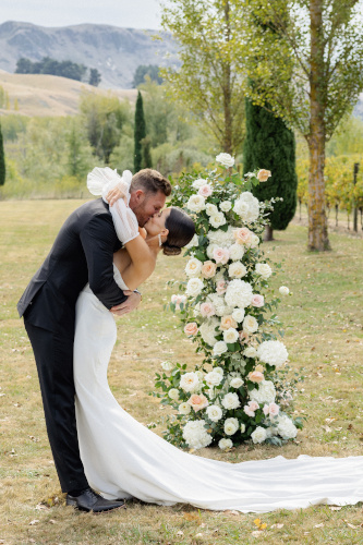 Bride, groom kiss after the vows.