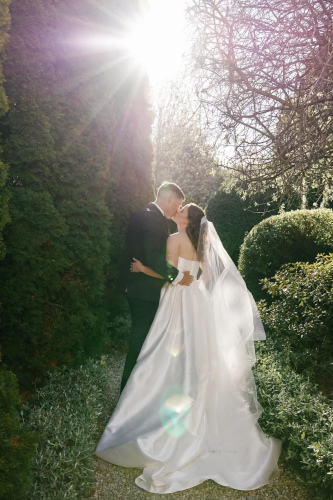 The bride and groom kissing.