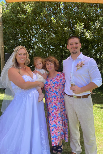 The bride and groom with their baby.