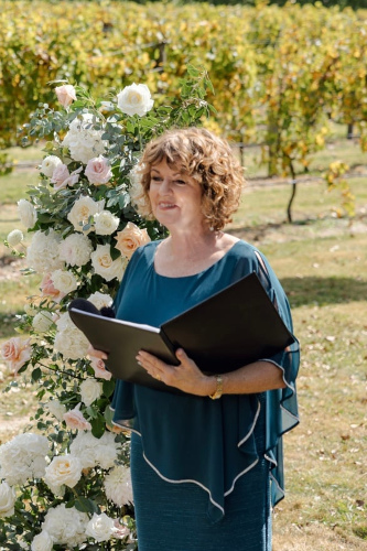 Debbie officiating at a ceromonie held in at vineyard.